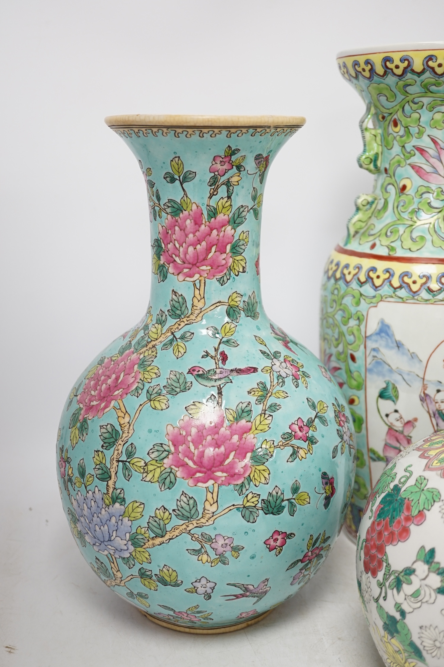 Two 20th century Chinese famille rose vases and a similar jar and cover, tallest 40cm. Condition - good